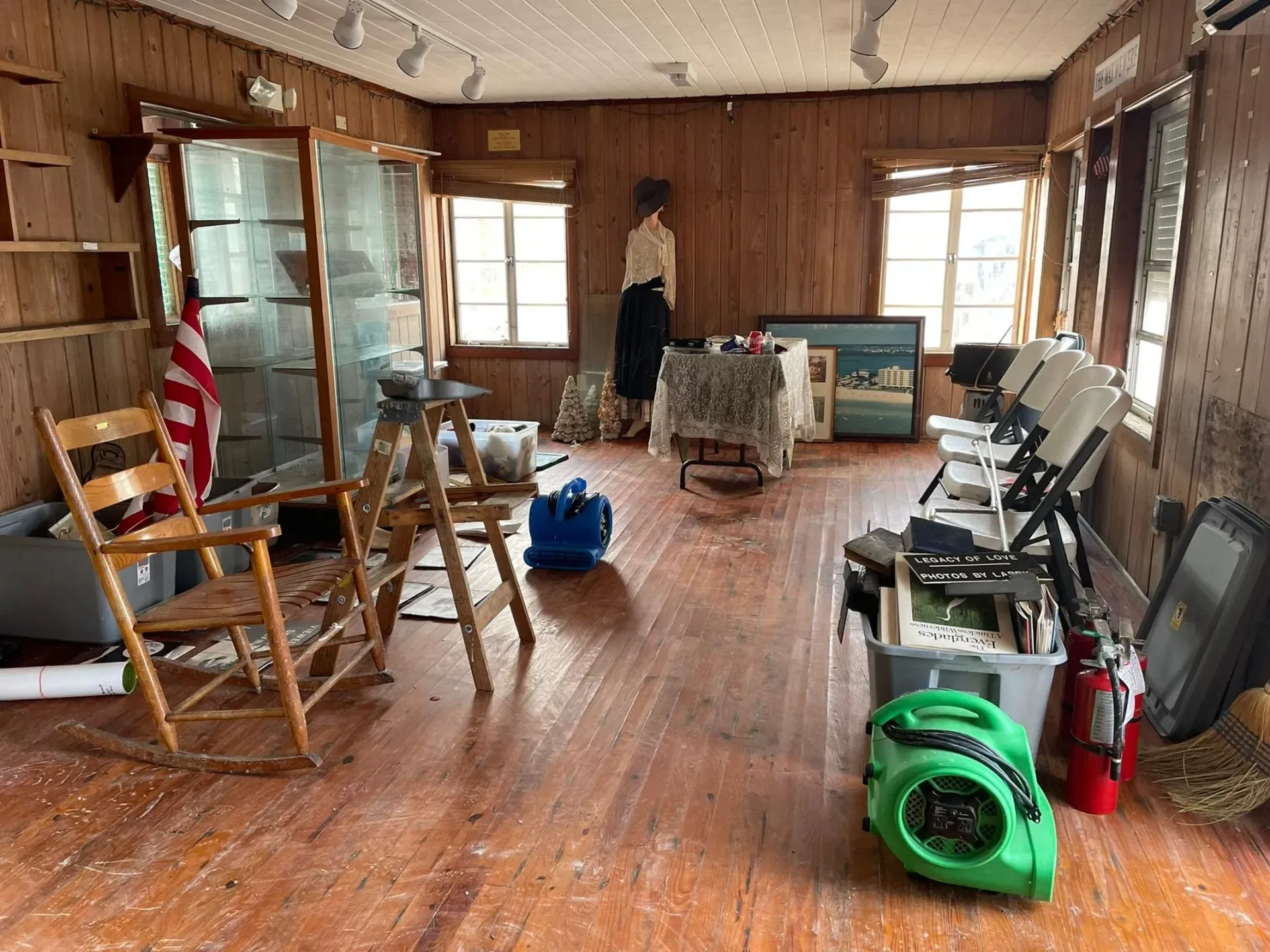 A living room filled with furniture and a green fan.