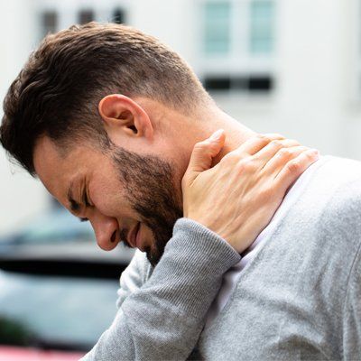 Neck Pain — Man Holding on His Neck In Cotuit, MA