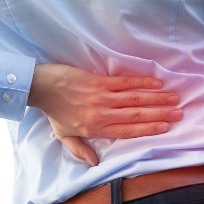 Back Pain — Man Holding on His Waist In Cotuit, MA
