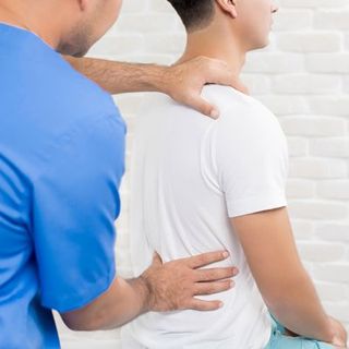 Chiropractic Care — Chiropractor Stretching Patient's Back In Cotuit, MA