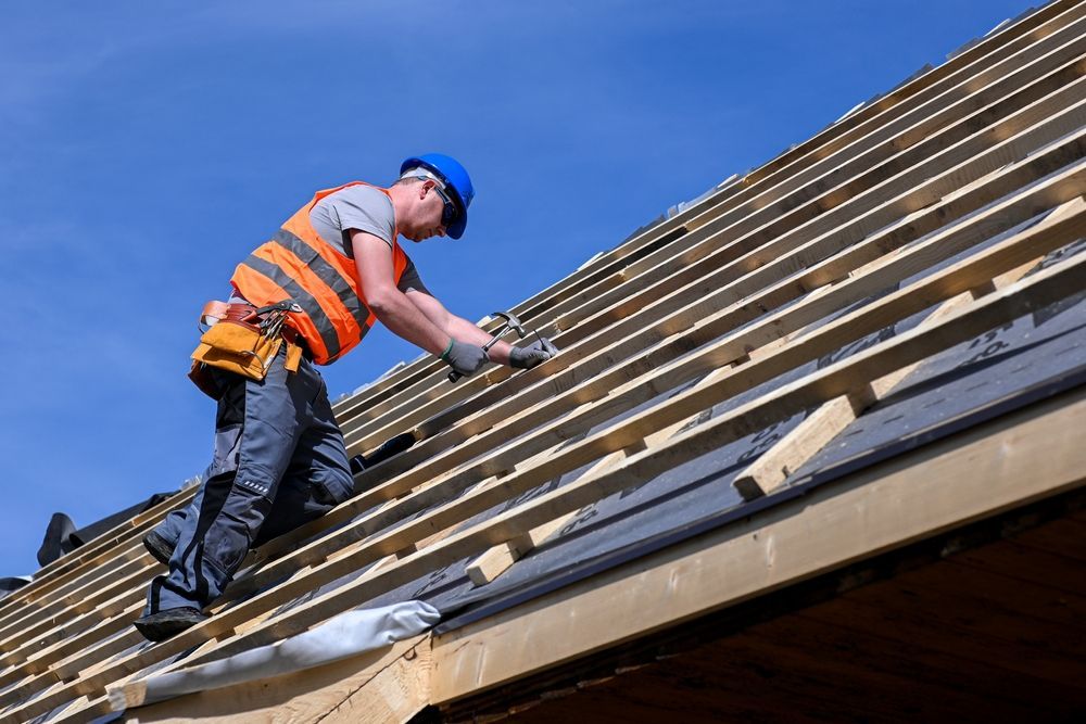 A man is working on the roof of a building.