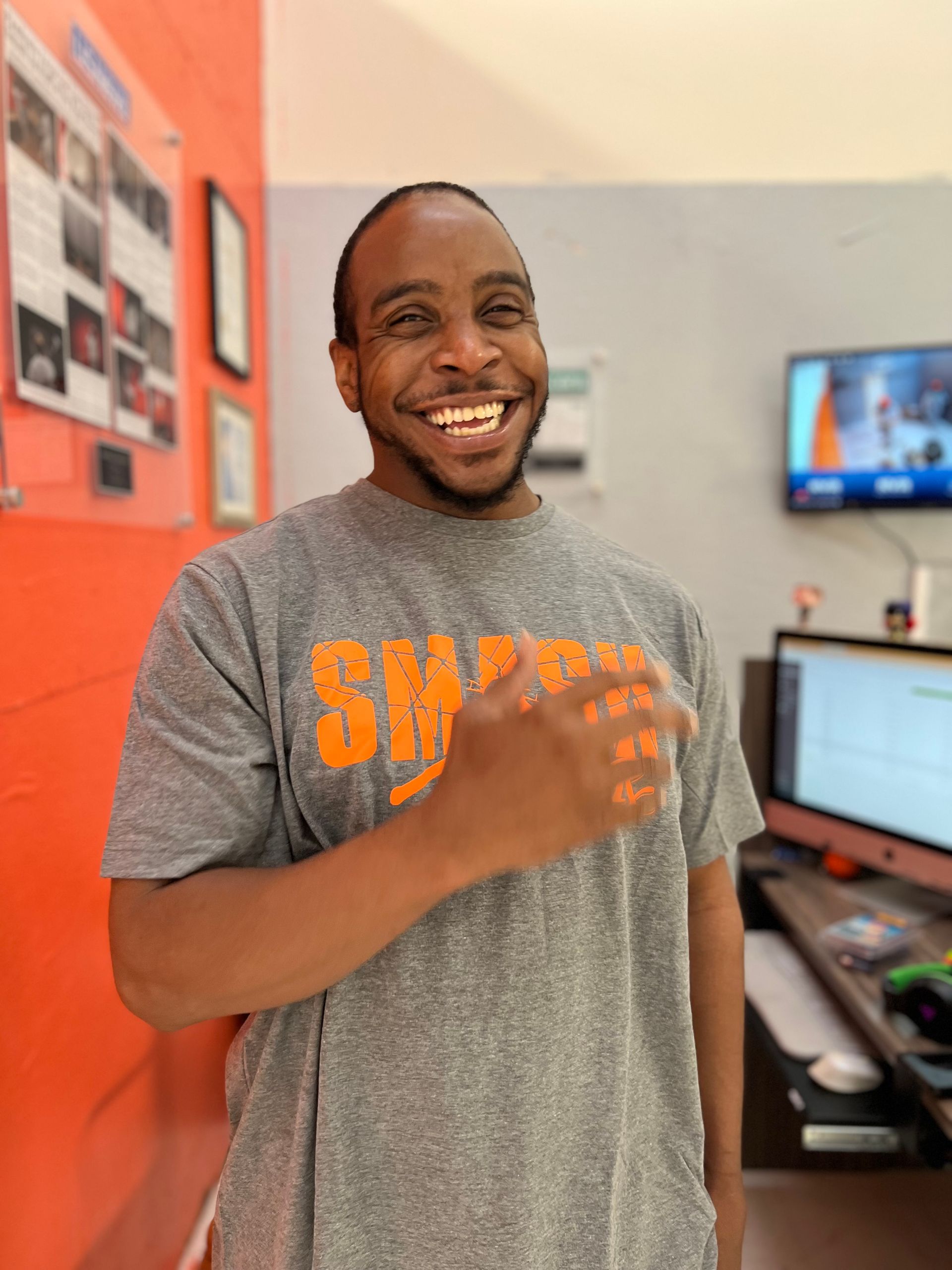 Hand gripping a hammer, bursting from a starburst-shaped sign.