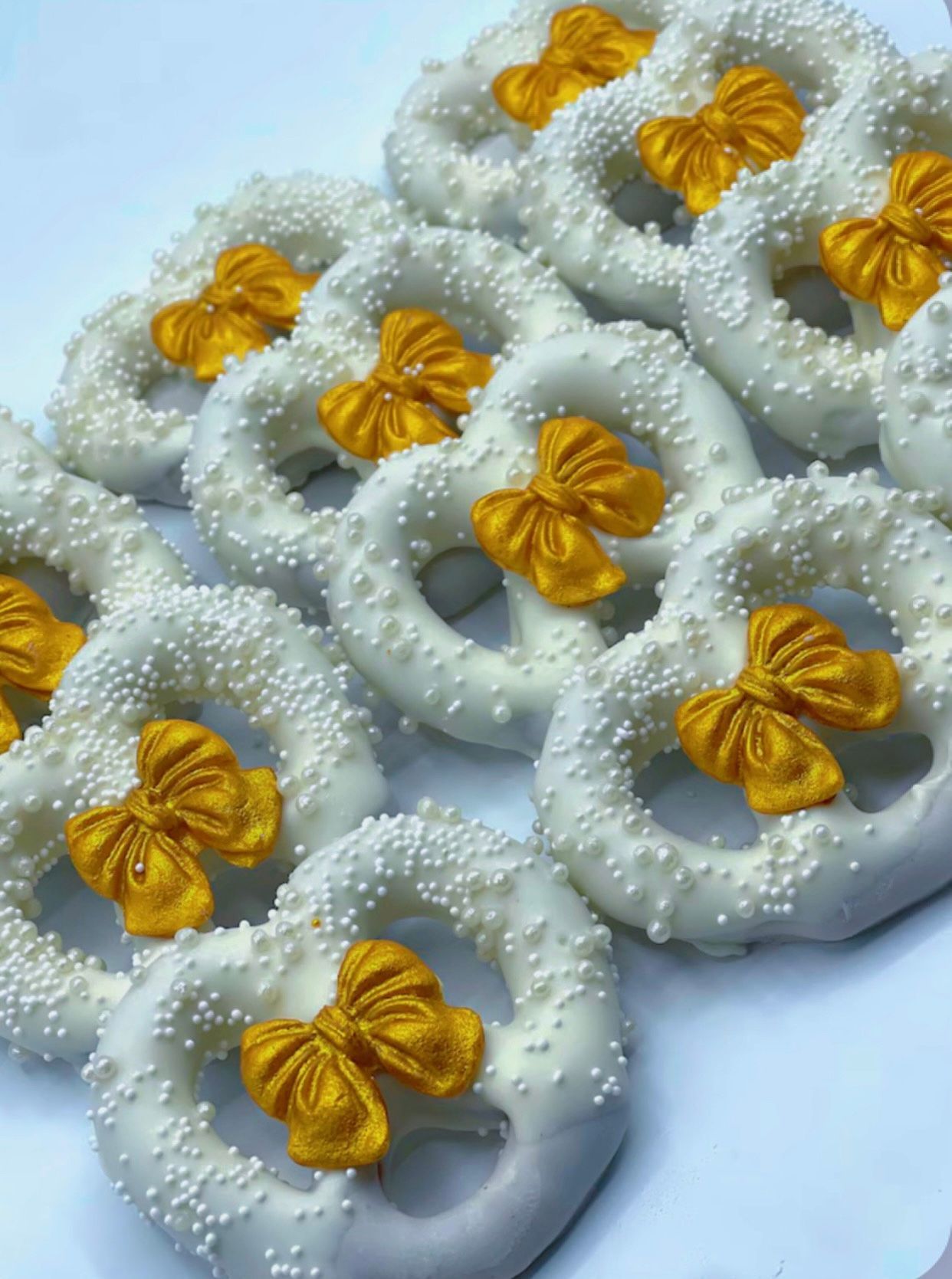 Slice of chocolate cake with chocolate frosting on a white plate with a gold fork, next to a mug of coffee.