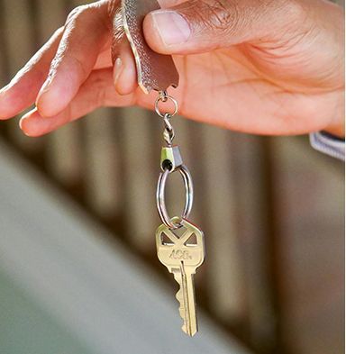 A person is holding a key with the letter a on it