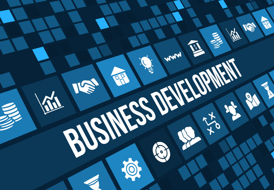 Person using a smartphone with email icons overlaying, near an open laptop in a cafe.