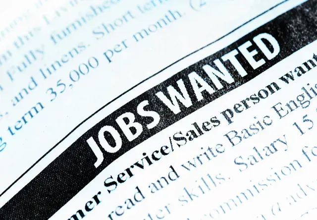 Close-up of a newspaper classified ad section with the headline 