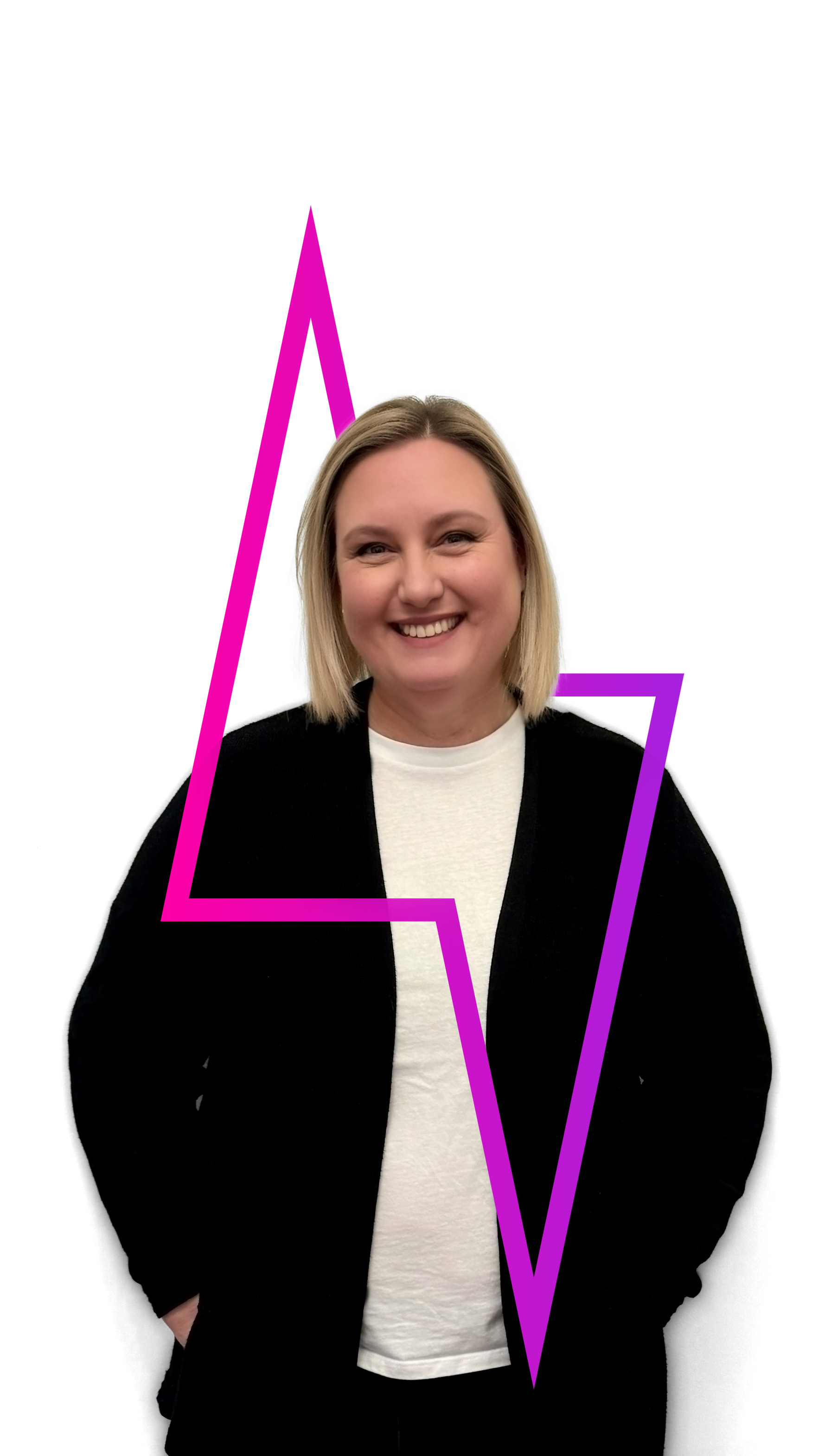 Woman smiling, hands in pockets, black blazer, white shirt. Pink and purple geometric shape.