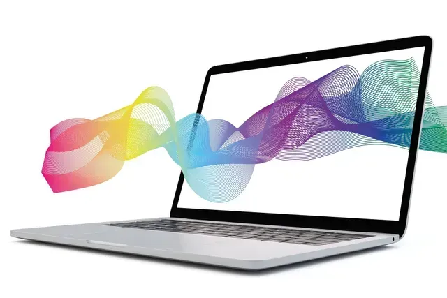 Laptop with colorful, wavy lines emanating from the screen, suggesting data or information flow.