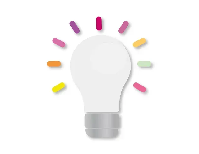 White lightbulb with colorful rays emanating from it.