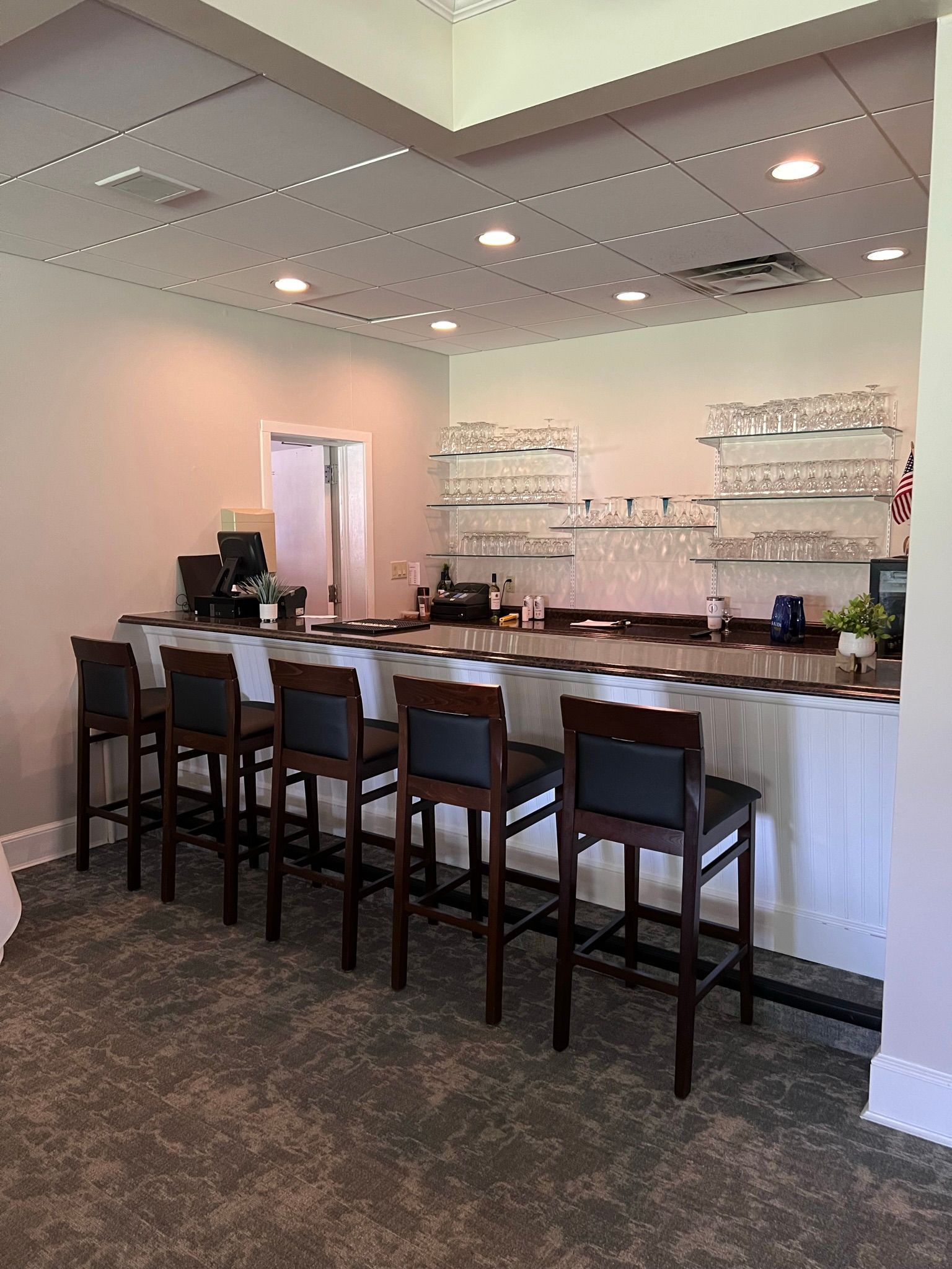 A long bar with a lot of chairs in a restaurant.