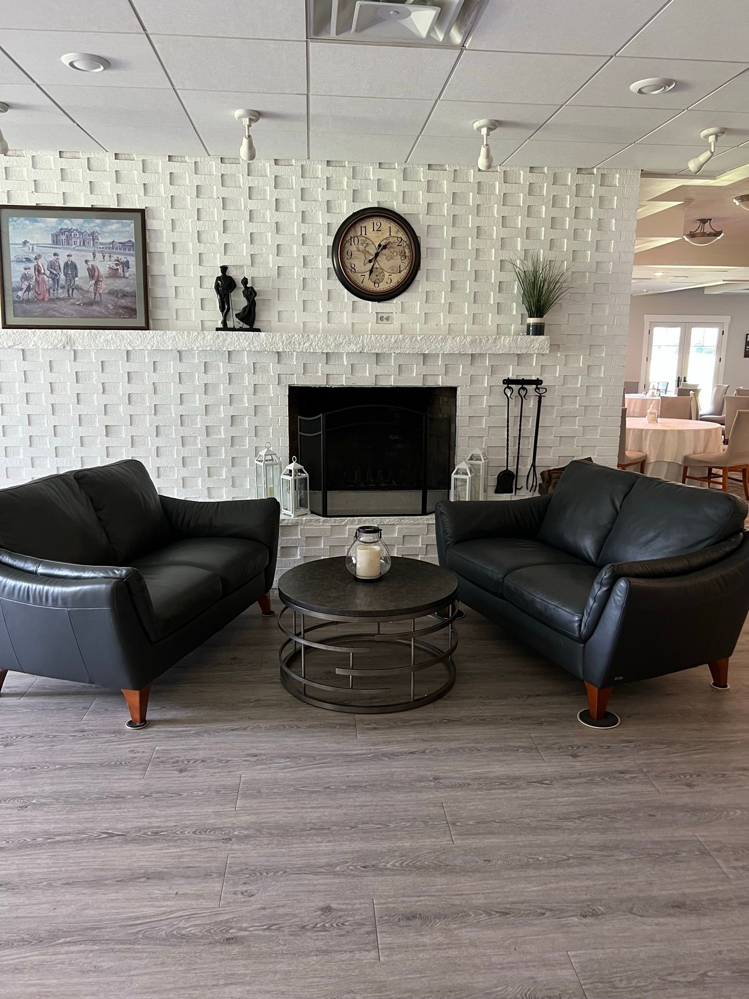 A living room with two couches , a table , and a fireplace.