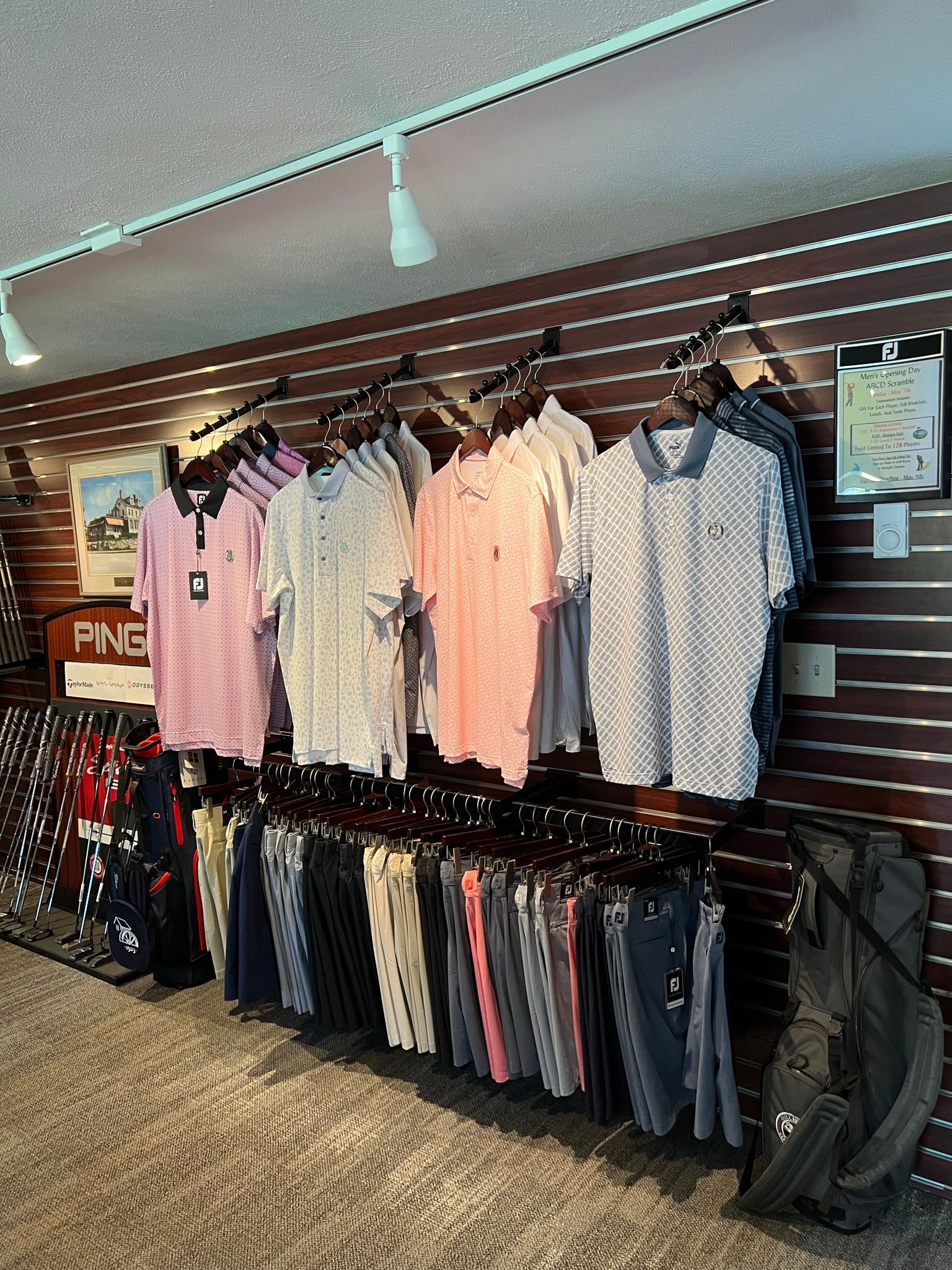 A row of shirts hanging on a wall in a store.