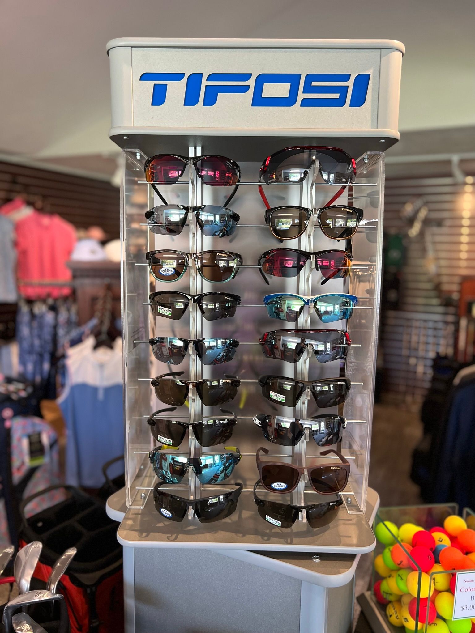 A display of sunglasses is sitting on a table in a store.