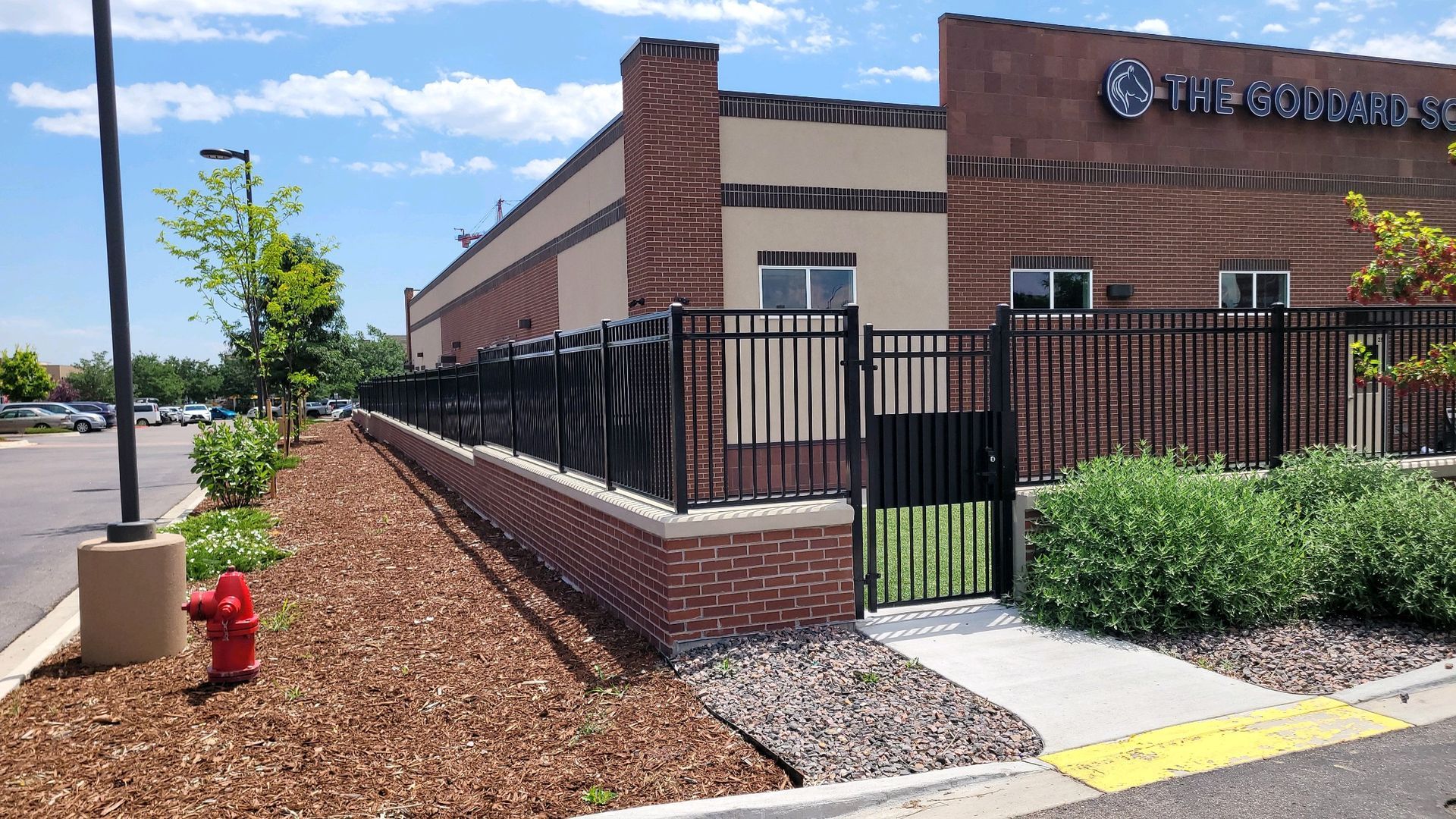 A fire hydrant is in front of a brick building
