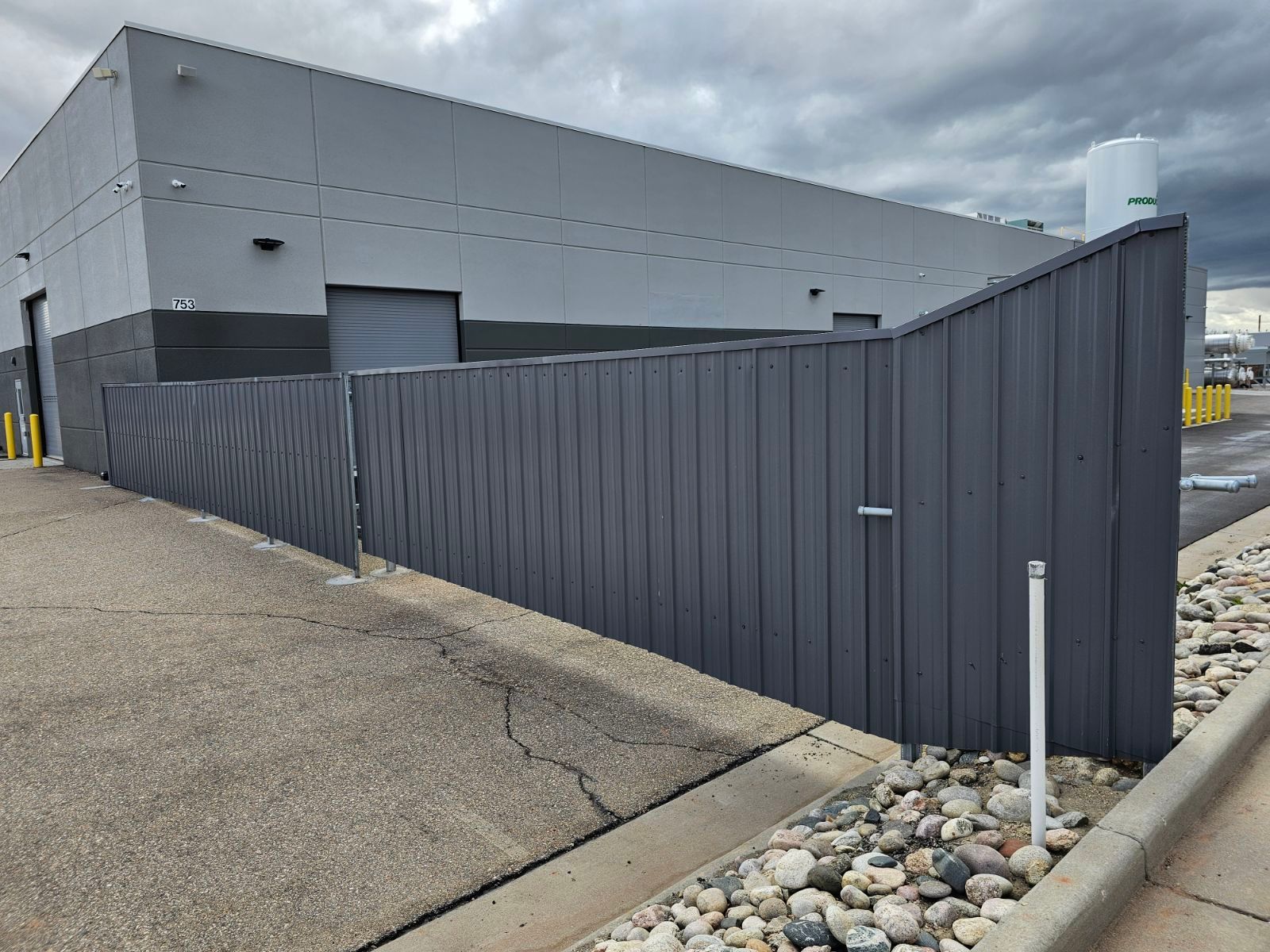 A large building with a fence built by Greater Western Fence in front of it.