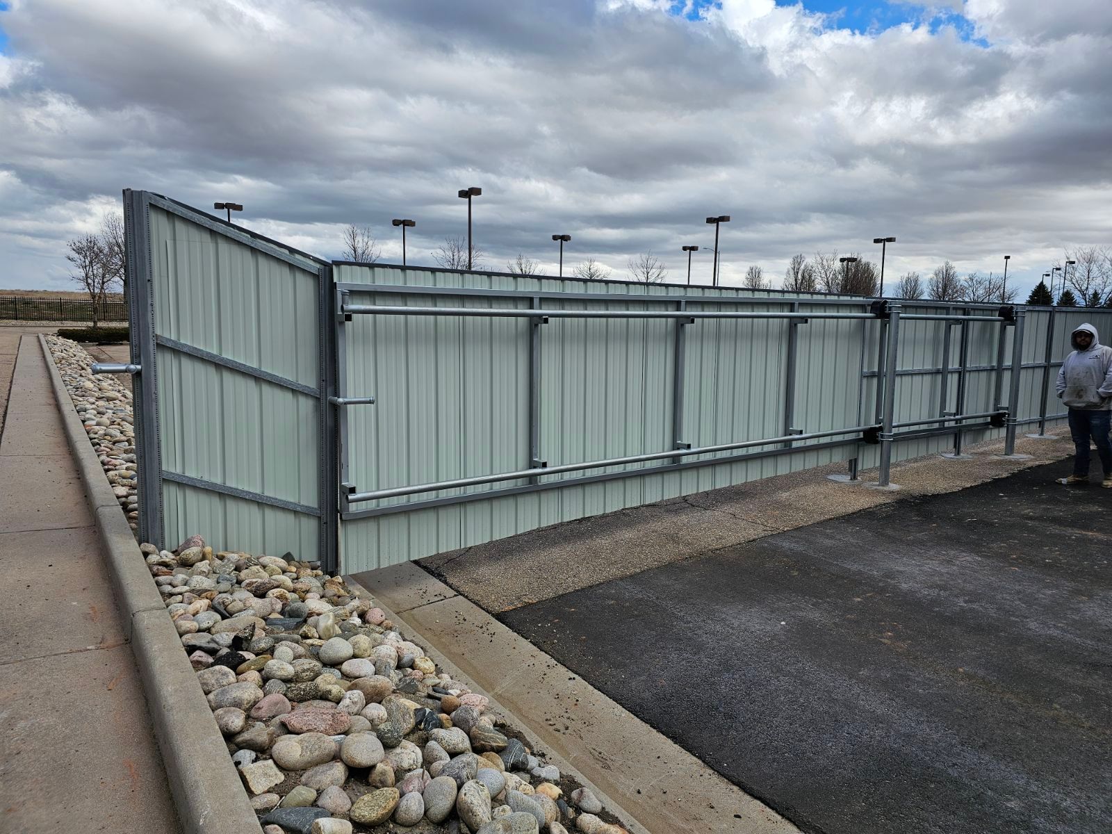A fence built by Greater Western Fence in a parking lot.