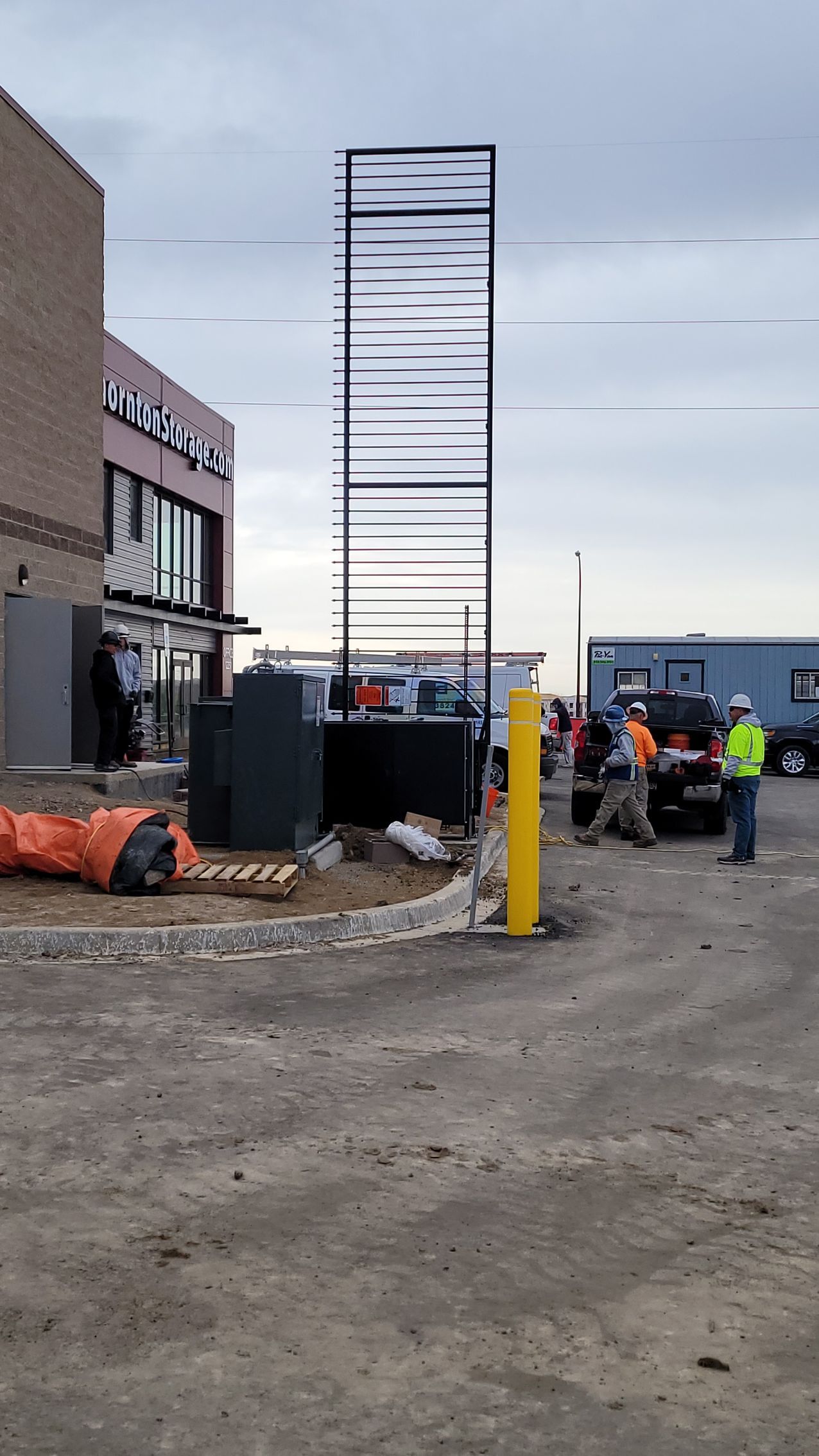 A large metal gate built by Greater Western Fencestructure is being built in front of a building.