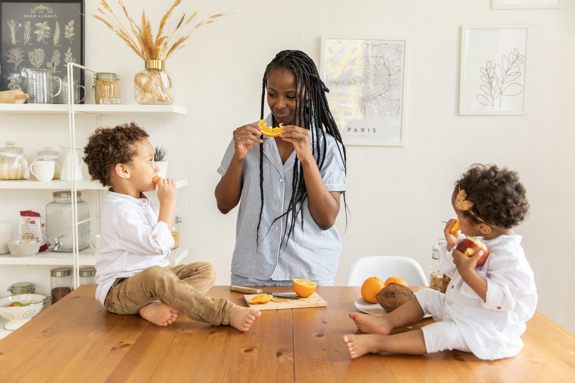 A mother and her children eating fruits