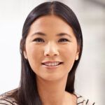 Woman with long dark hair smiles
