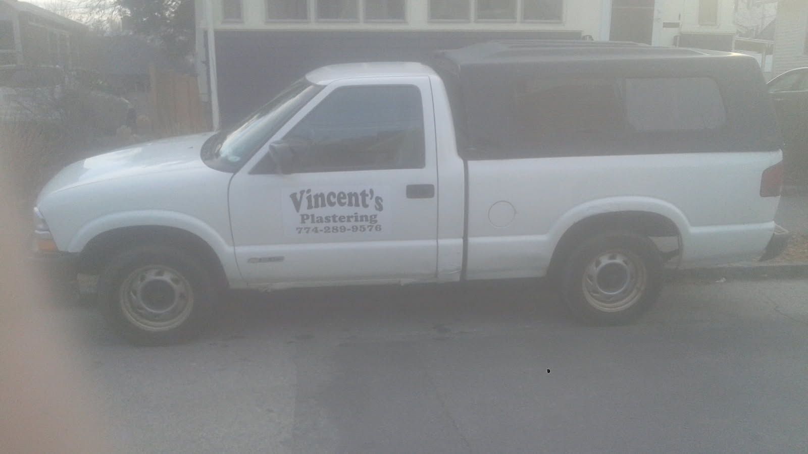 White pickup truck with black topper and 