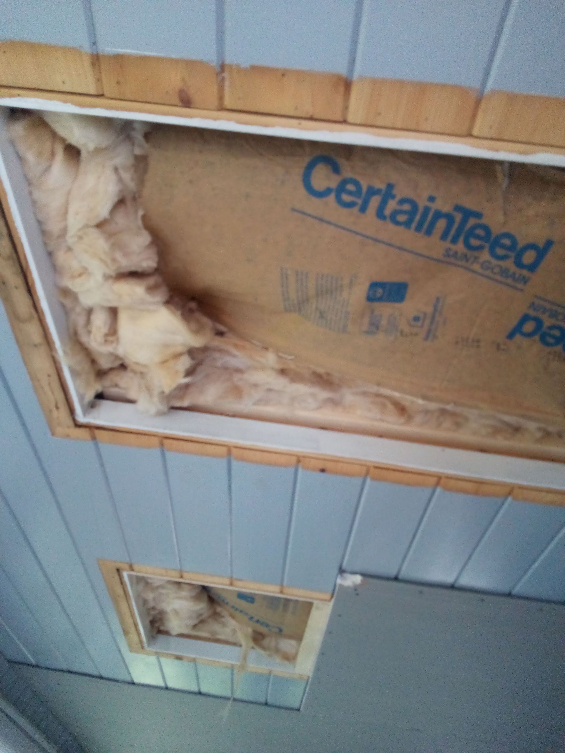 Ceiling with two open access panels, showing insulation and exposed CertainTeed board.