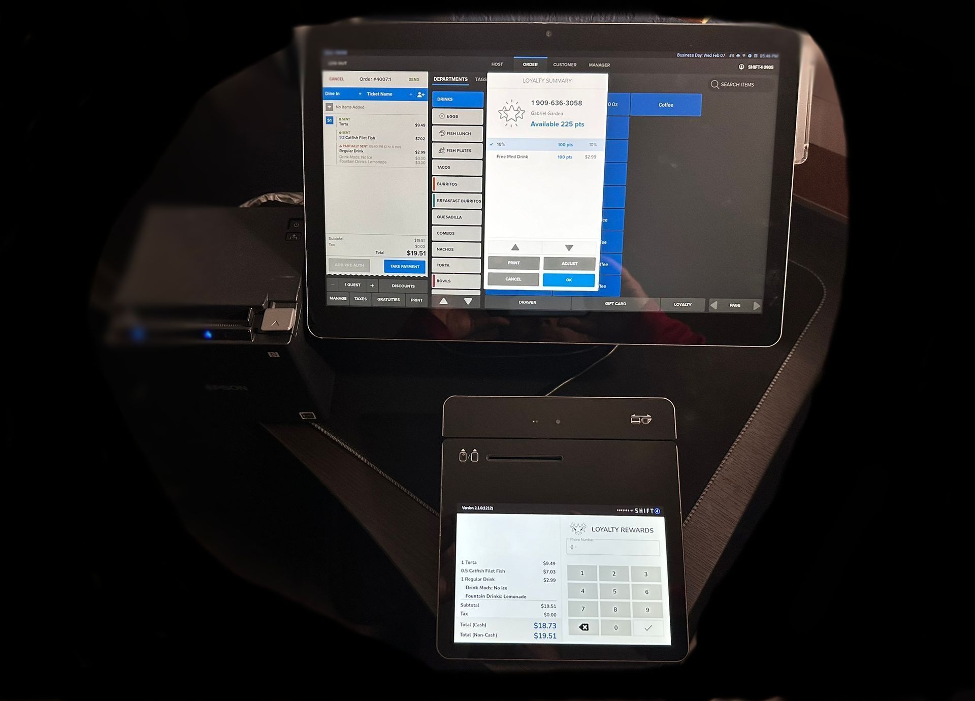 A SkyTab POS tablet and a Customer Display  are on a table