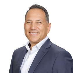 Man in navy suit, white shirt, smiling against a white background. Profitability Consultant helping Local Restaurants 