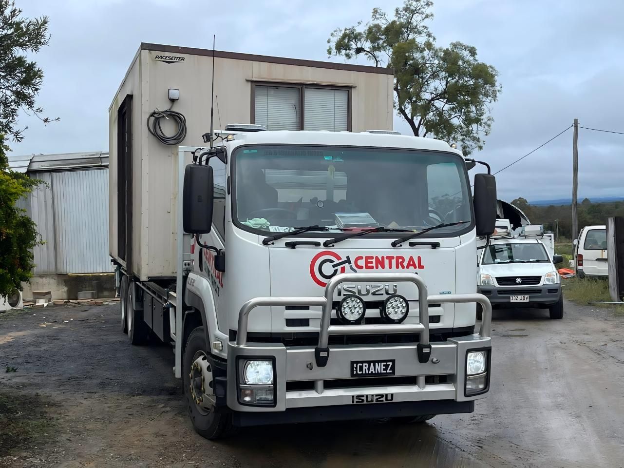 A White Truck With the Word Central on the Front is Parked in Front of a Building — Central Crane Trucks In Brisbane, QLD