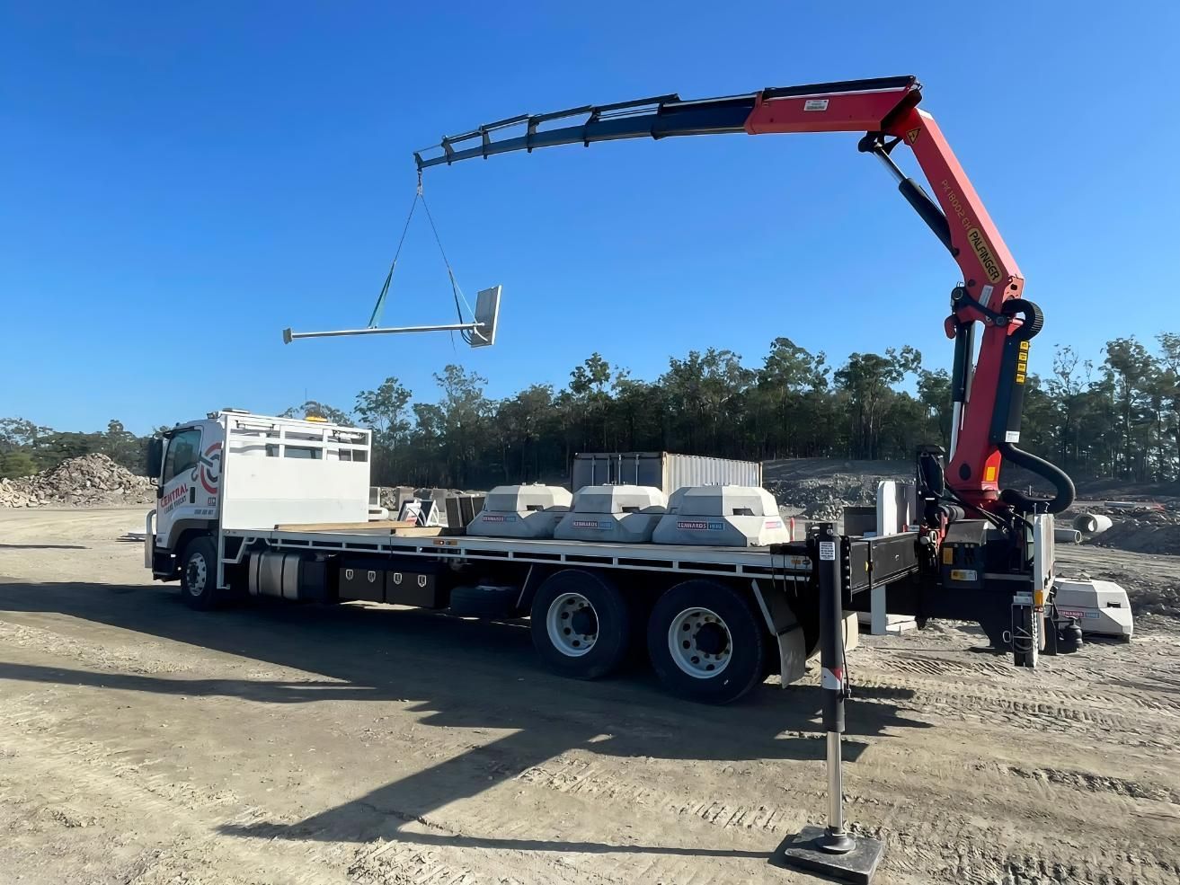 A Truck With a Crane Attached to It is Parked on a Dirt Road — Central Crane Trucks In Brisbane, QLD