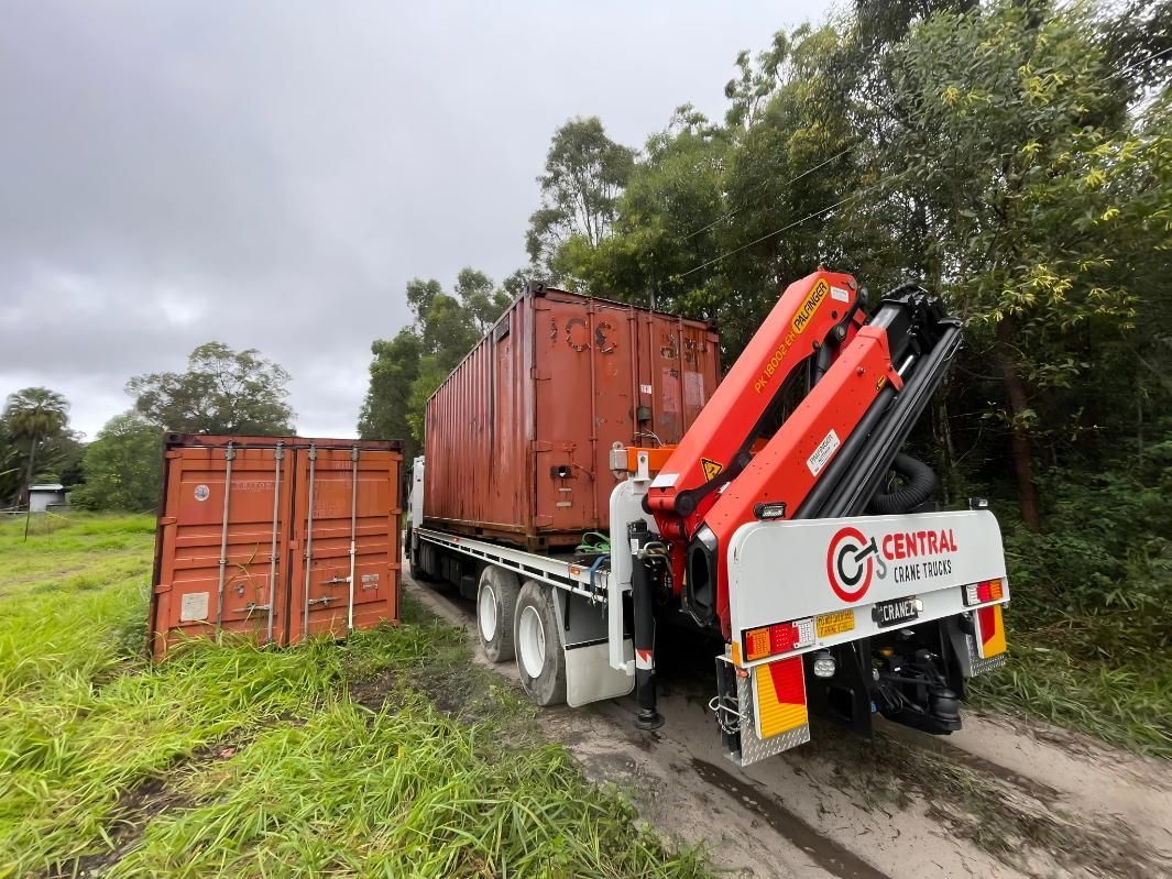 A Truck With a Crane on the Back of It is Carrying a Shipping Container — Central Crane Trucks In Brisbane, QLD