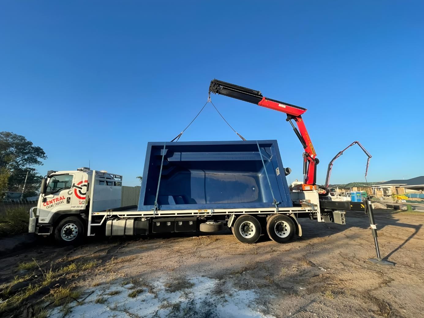 A Truck With a Crane Attached to It is Carrying a Large Swimming Pool — Central Crane Trucks In Brisbane, QLD