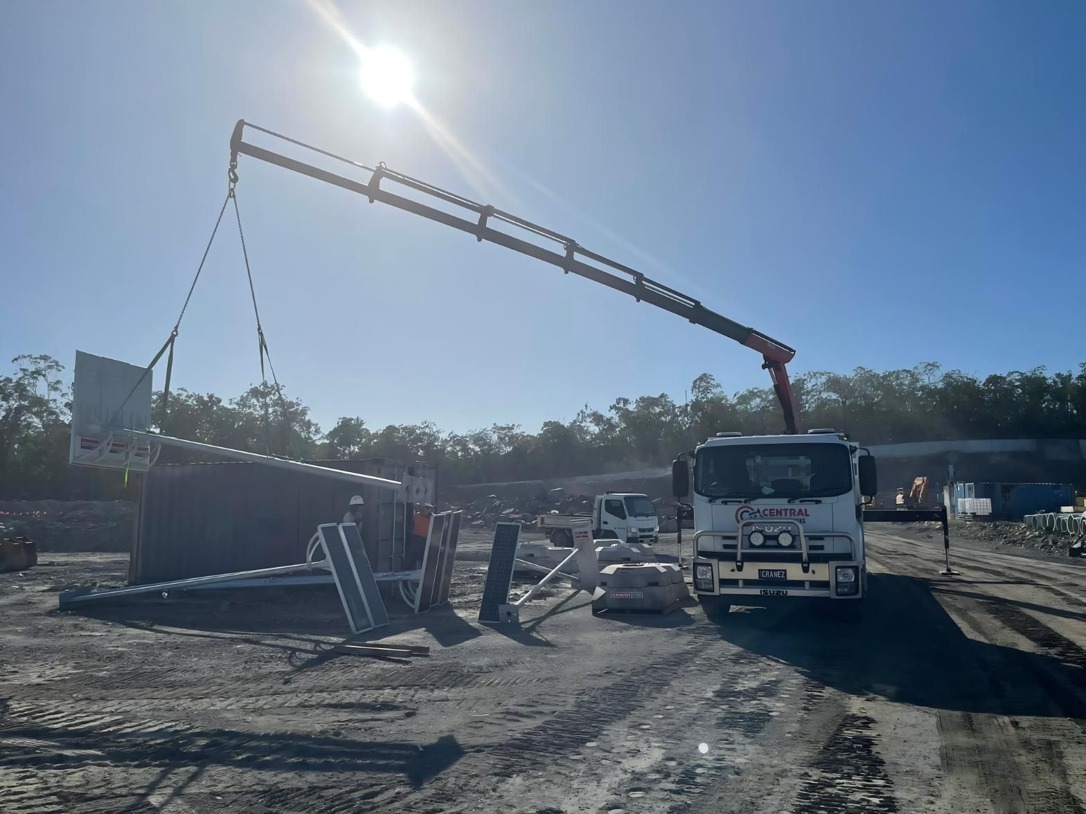 A Crane is Being Used to Lift a Fence in a Construction Site — Central Crane Trucks In Stapylton, QLD