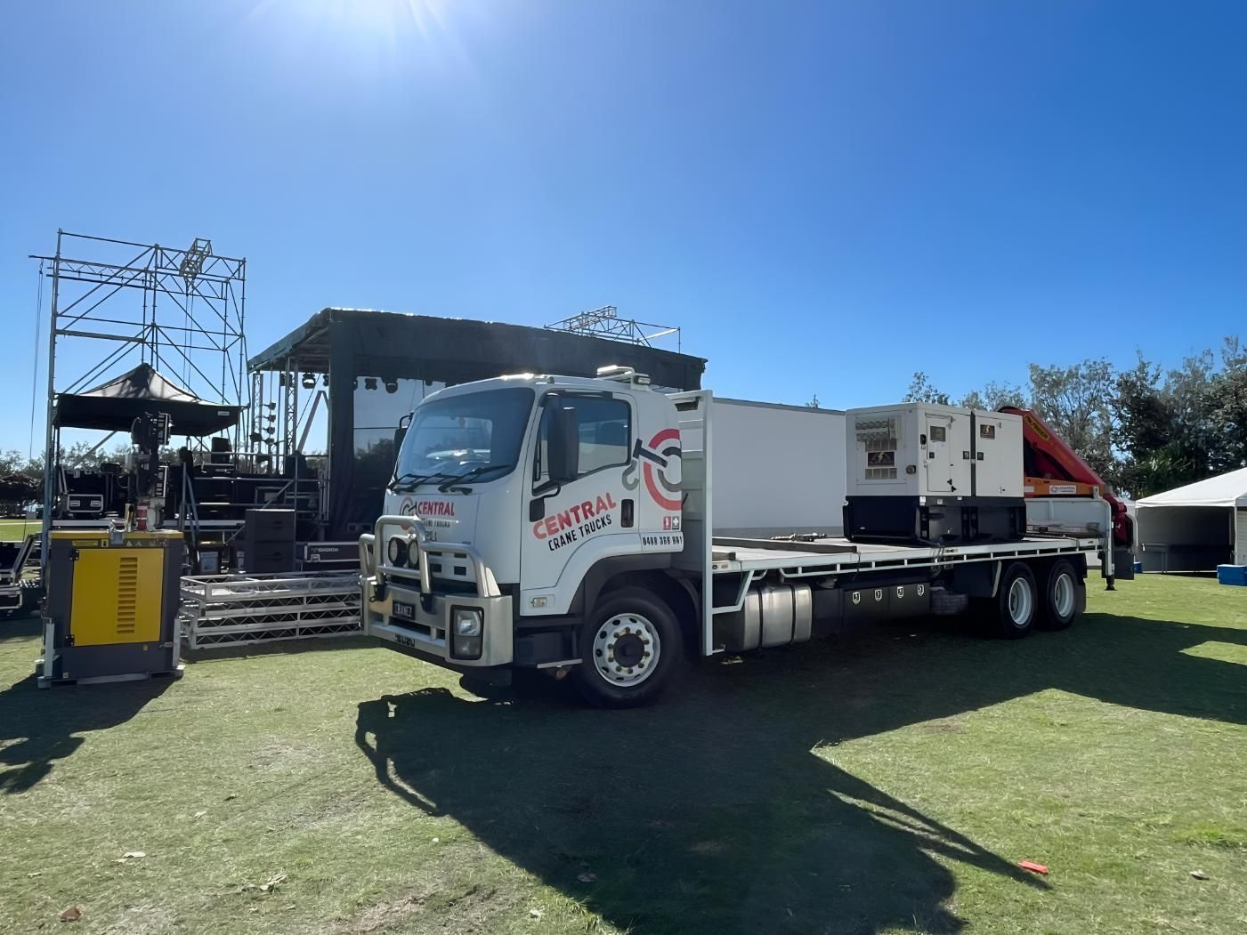 A Large White Truck is Parked in a Grassy Field — Central Crane Trucks In Gold Coast, QLD