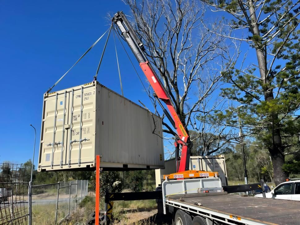 A Crane is Lifting a Shipping Container on Top of a Truck — Central Crane Trucks In Gold Coast, QLD