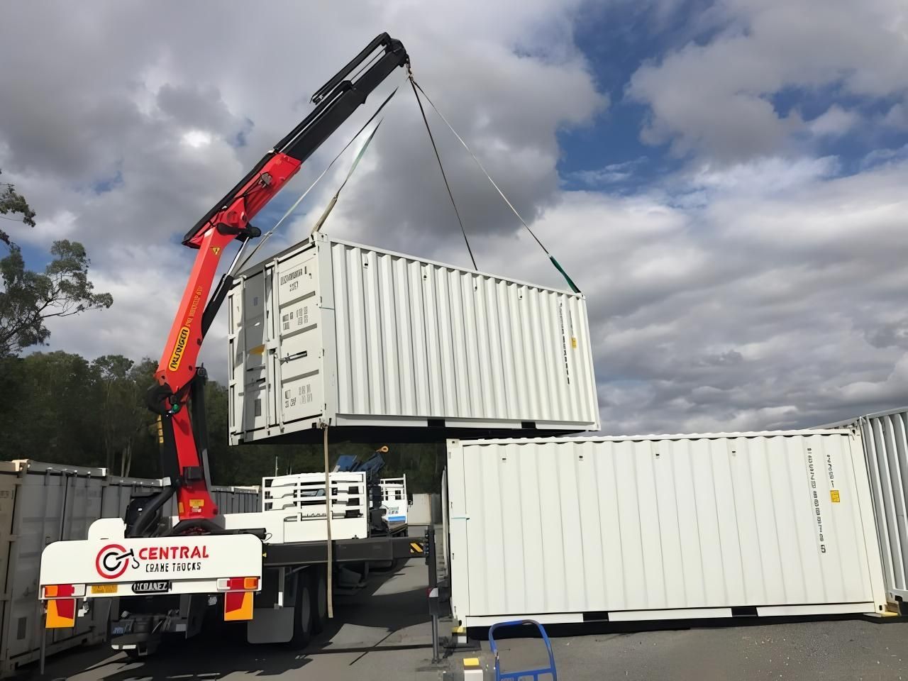 A Crane is Lifting a Shipping Container in a Parking Lot — Central Crane Trucks In Stapylton, QLD