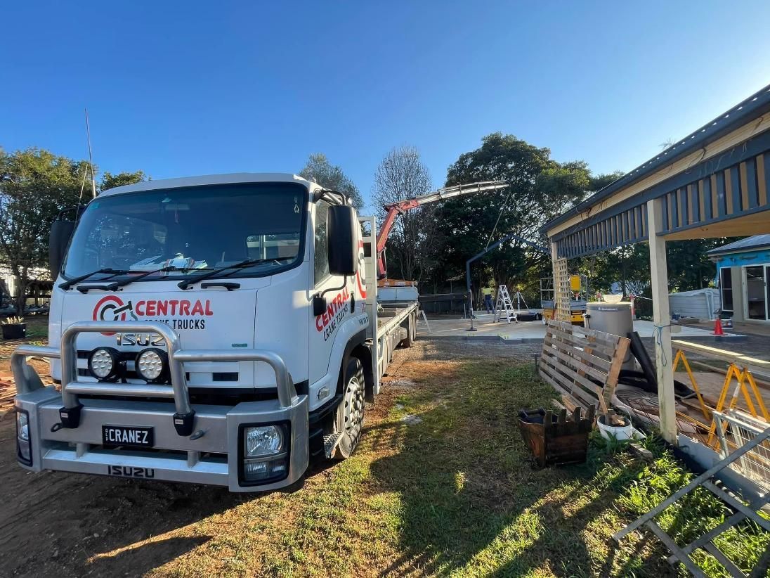 A Truck With a Crane is Parked in Front of a Building Under Construction — Central Crane Trucks In Stapylton, QLD