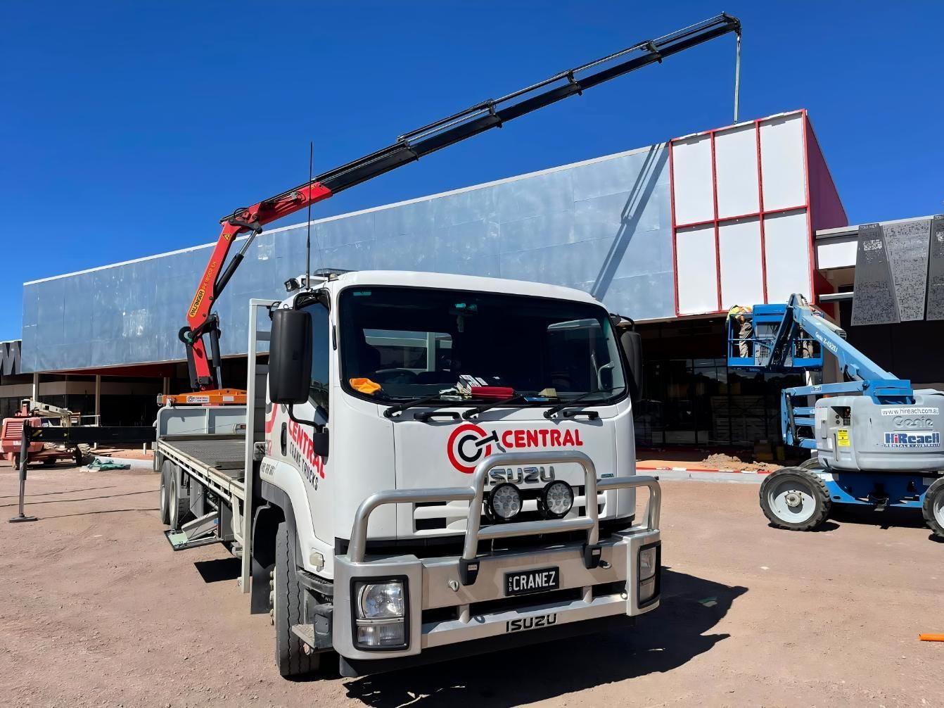 A White Truck is Parked in Front of a Building Under Construction — Central Crane Trucks In Stapylton, QLD