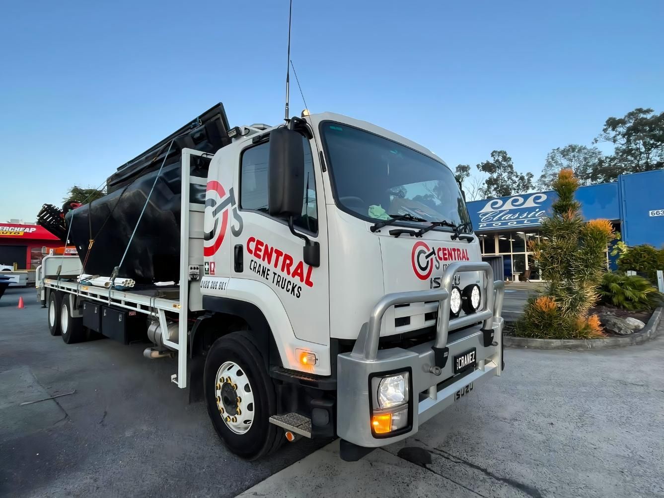 A White Truck With the Word Central on the Side is Parked in a Parking Lot — Central Crane Trucks In Stapylton, QLD