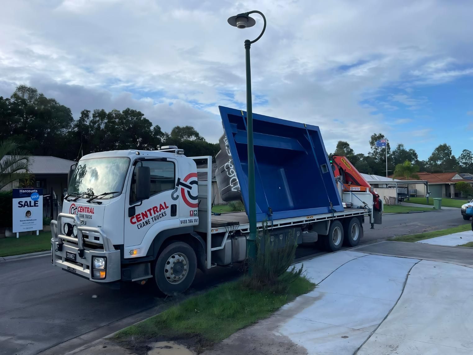 A Dump Truck is Parked on the Side of the Road Next to a Street Light — Central Crane Trucks In Stapylton, QLD