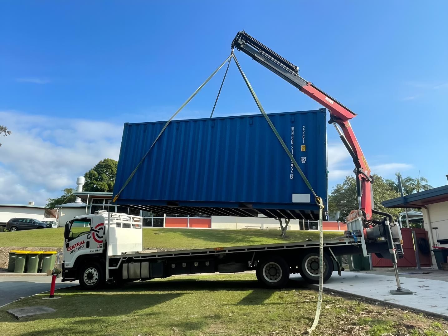A Blue Shipping Container is Being Lifted by a Crane on a Flatbed Truck — Central Crane Trucks In Stapylton, QLD