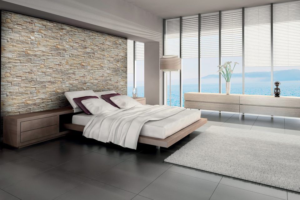 camera da letto con parete in pietra naturale