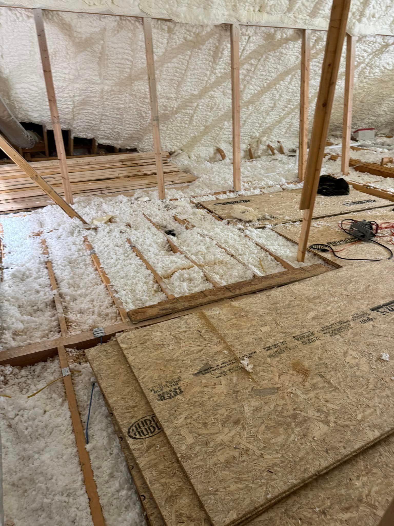 A stack of plywood sitting on top of a wooden floor.