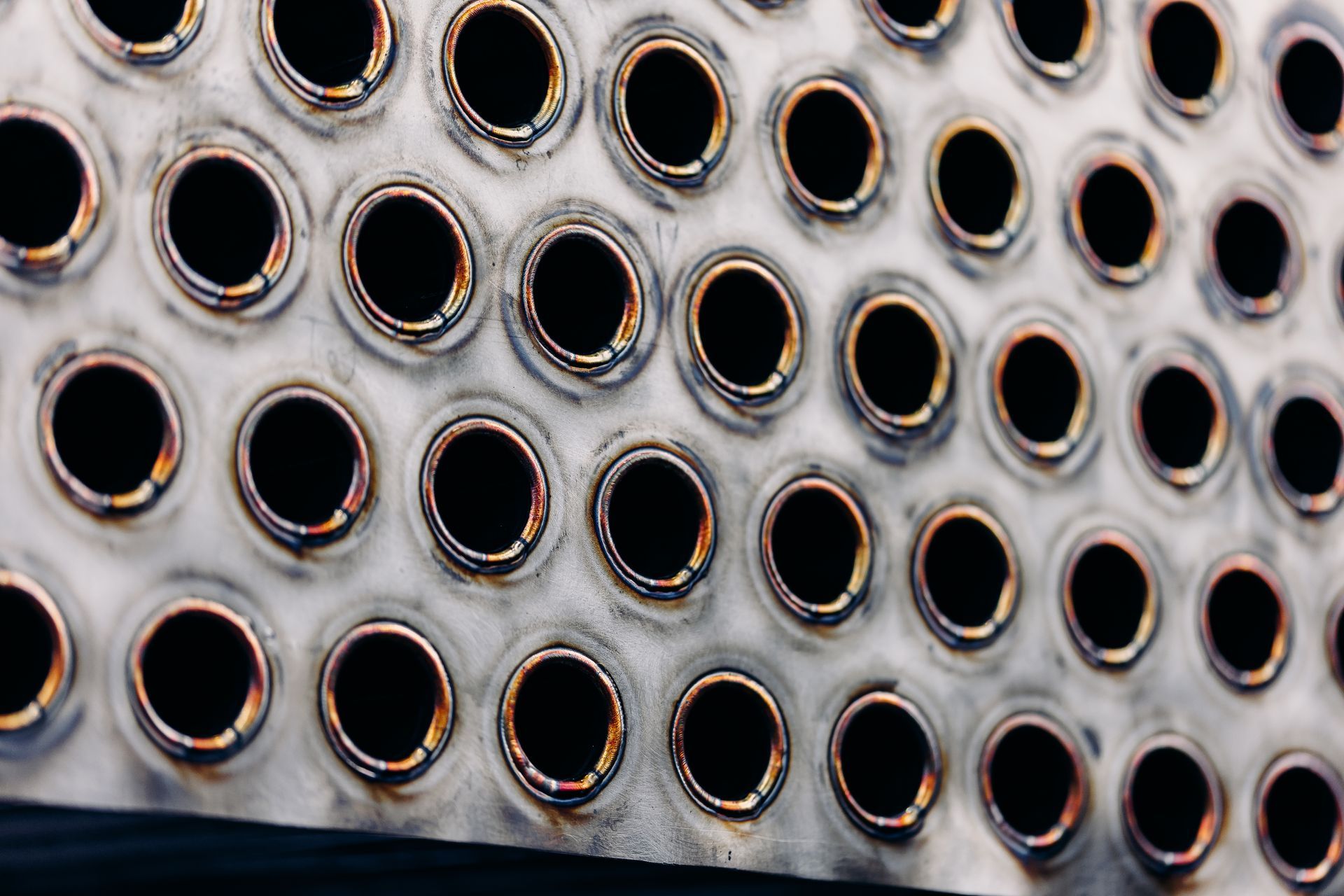 Perforated metal sheet with numerous circular holes, with welded edges, possibly industrial.