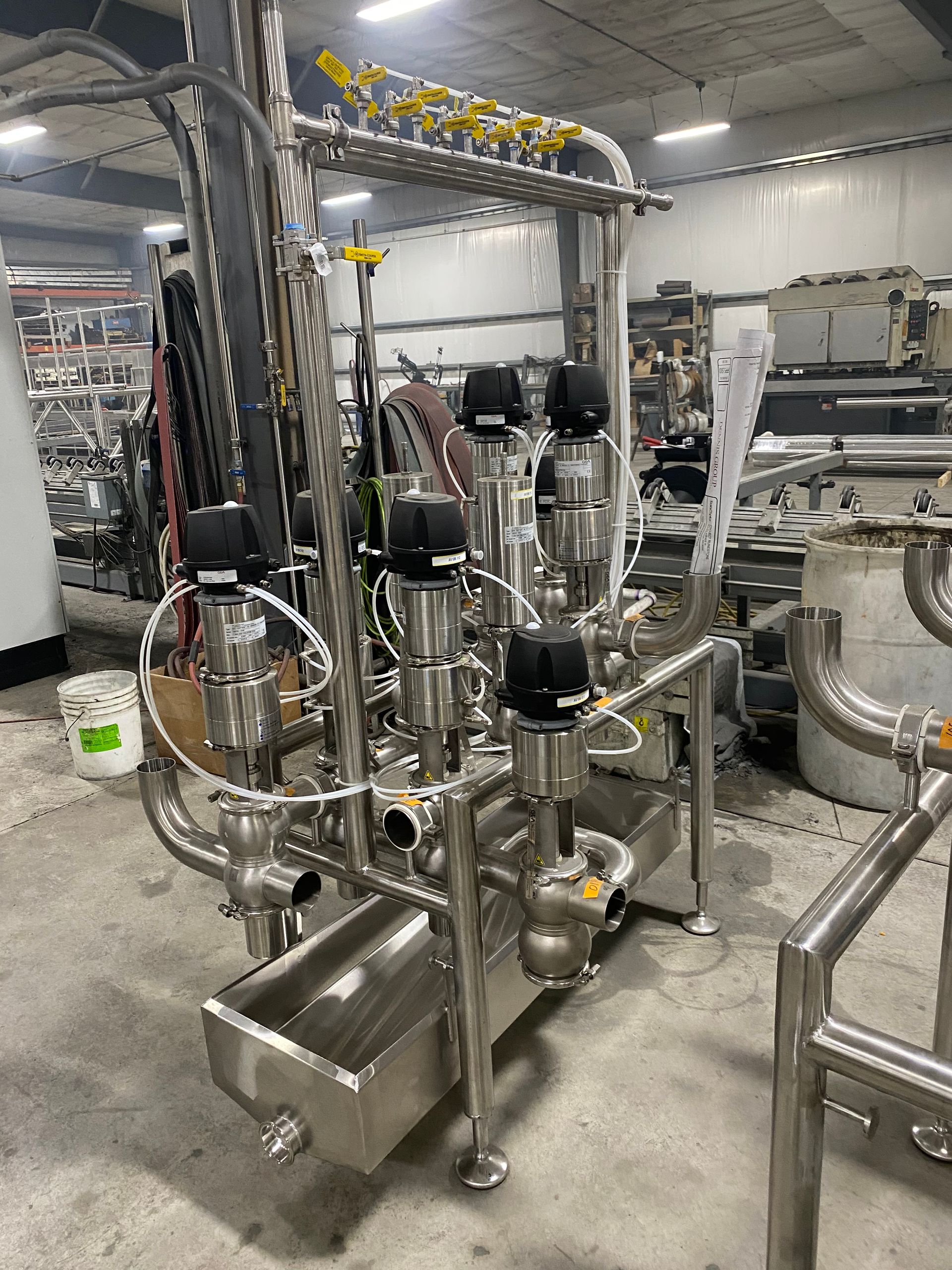 Stainless steel industrial machinery with various pipes, valves