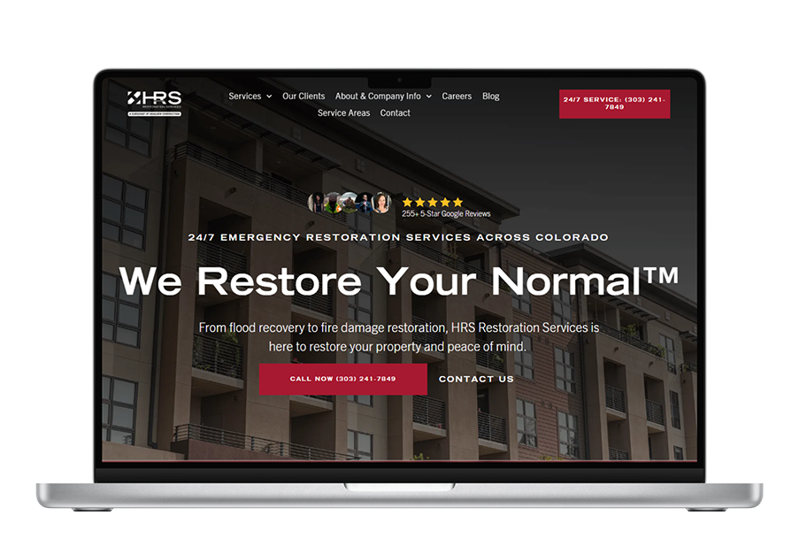 Laptop displaying a website for restoration services; “We Restore Your Normal” with a building backdrop.