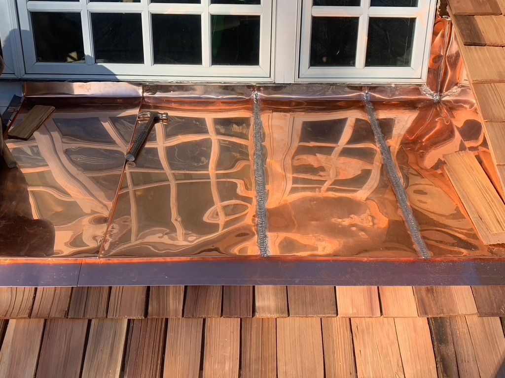 Standing seam copper roofing.