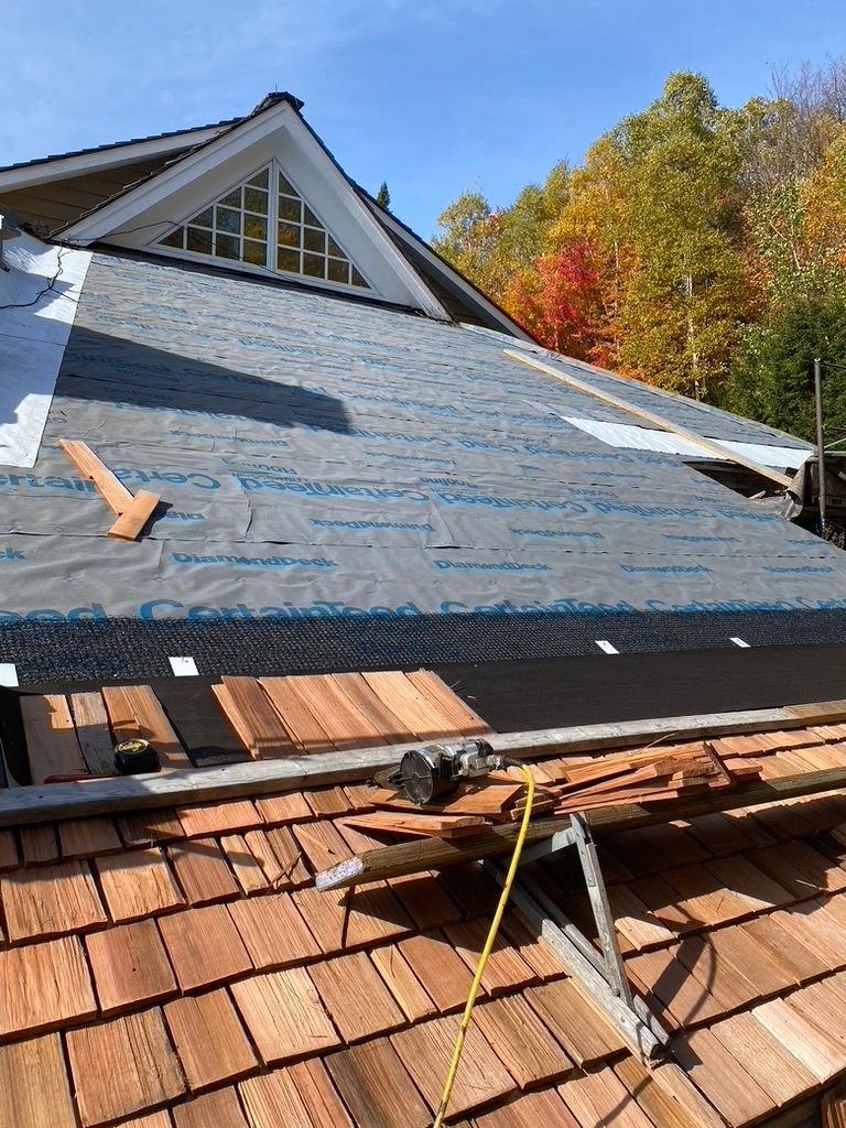 A wooden roof is being installed on a house.