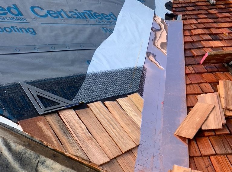 A roof that is under construction in Vermont with the flashing at the forefront. 