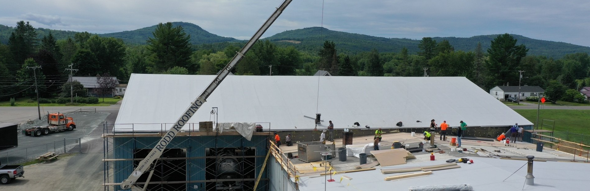 A group of Rodd Roofing employees working on top of a roof