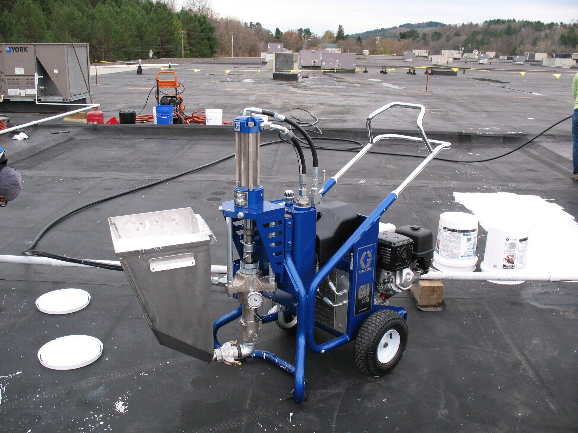 A blue and silver machine is sitting on a roof